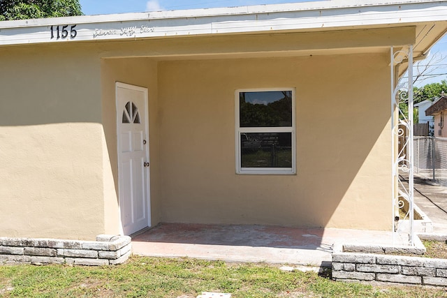 doorway to property with stucco siding