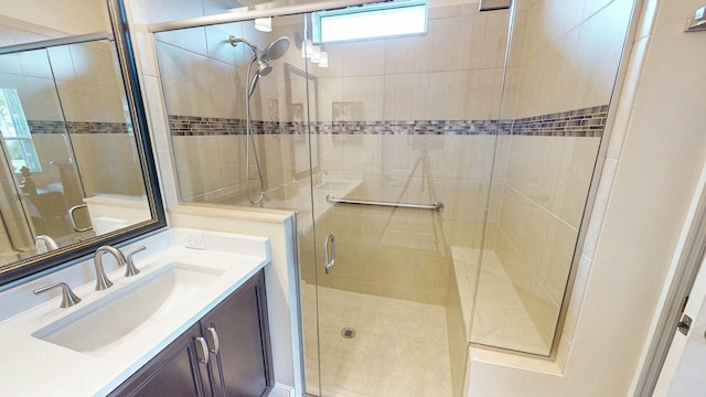 full bath with a stall shower and vanity