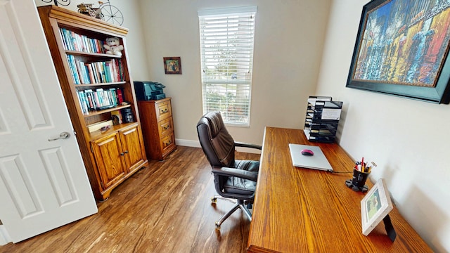 office area with baseboards and wood finished floors