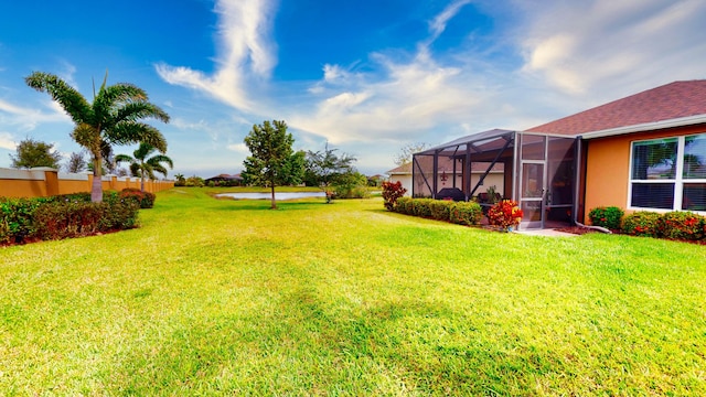 view of yard with glass enclosure