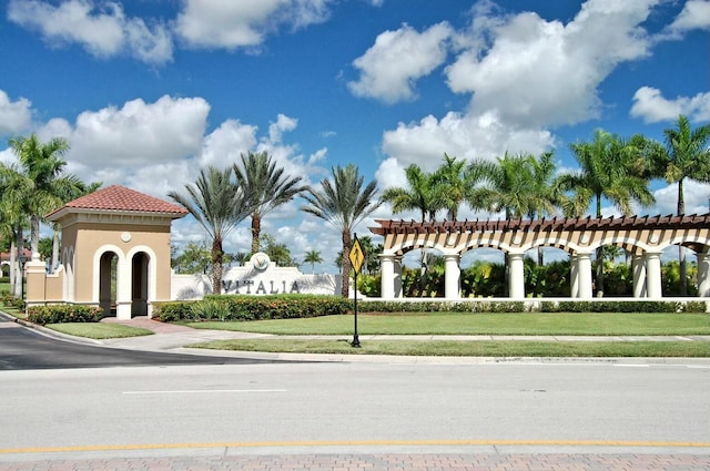 view of home's community with a pergola and a lawn