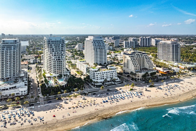 birds eye view of property featuring a city view, a water view, and a beach view