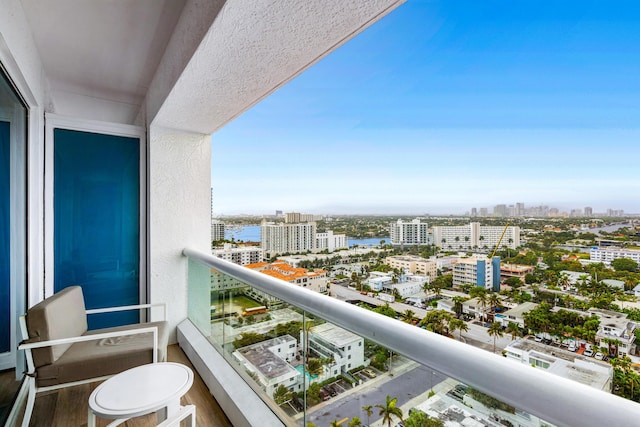 balcony with a water view and a city view