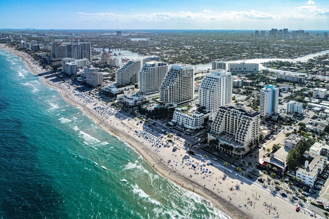 birds eye view of property with a view of city, a water view, and a beach view