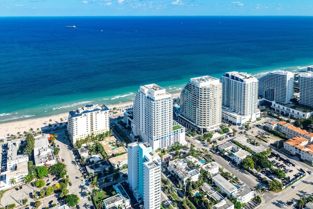 bird's eye view featuring a view of the beach, a water view, and a city view