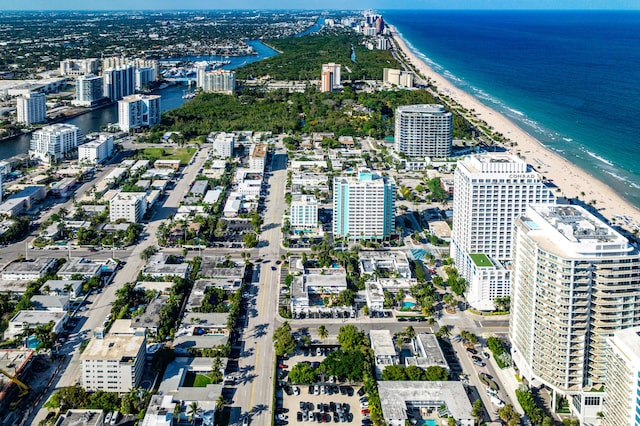 birds eye view of property featuring a water view, a beach view, and a city view