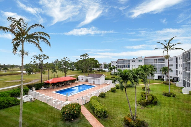 community pool with a yard and fence