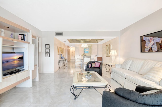 living area with light tile patterned floors and visible vents