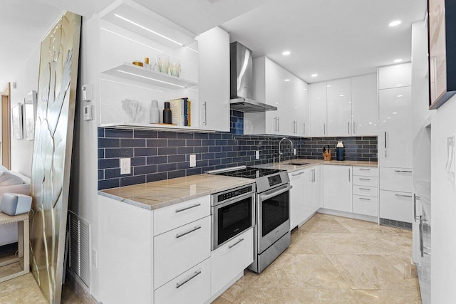 kitchen with visible vents, wall chimney exhaust hood, modern cabinets, stainless steel range with electric stovetop, and open shelves