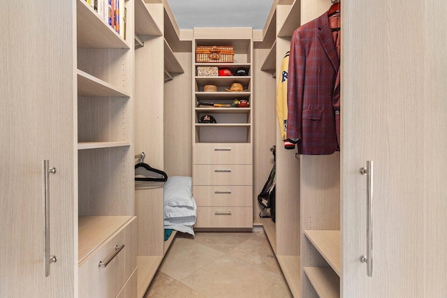 spacious closet featuring light tile patterned floors