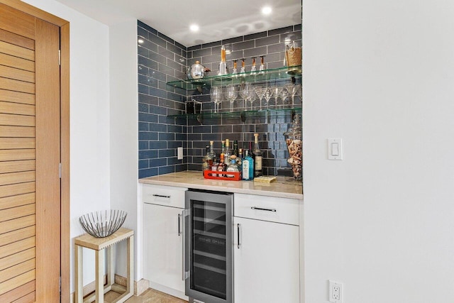 bar featuring recessed lighting, beverage cooler, backsplash, and a dry bar