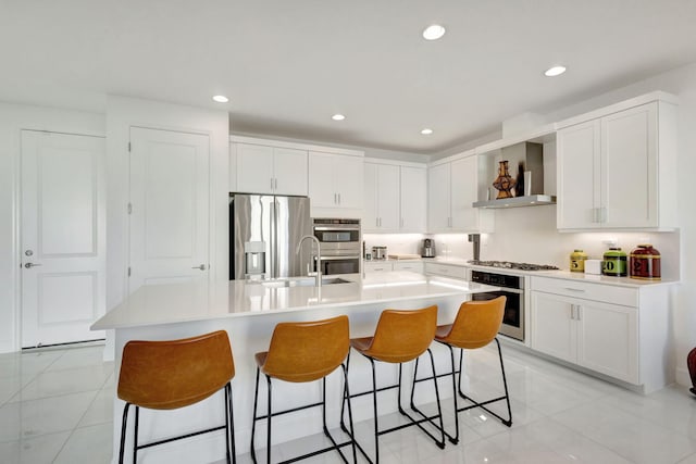 1396 Bushel Creek Xing, Loxahatchee, FL 33470 - kitchen with appliances with stainless steel finishes, a sink, wall chimney range hood, light tile patterned floors, and recessed lighting