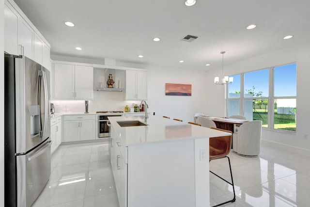 1396 Bushel Creek Xing, Loxahatchee, FL 33470 - kitchen with appliances with stainless steel finishes, a sink, wall chimney range hood, recessed lighting, and light countertops