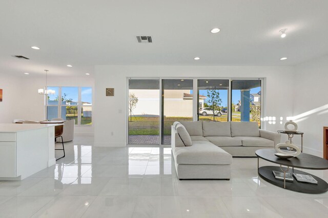 1396 Bushel Creek Xing, Loxahatchee, FL 33470 - living room featuring recessed lighting, baseboards, a chandelier, and light tile patterned floors