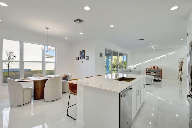 1396 Bushel Creek Xing, Loxahatchee, FL 33470 - kitchen featuring a sink, dishwasher, a center island with sink, light countertops, and white cabinetry