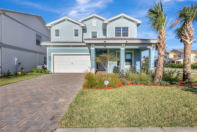 1396 Bushel Creek Xing, Loxahatchee, FL 33470 - traditional home featuring decorative driveway, a porch, a front lawn, and a garage