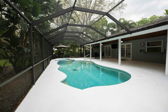 view of swimming pool with french doors, a patio, a pool with connected hot tub, and a lanai