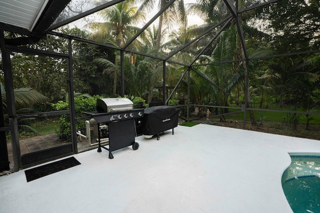 view of patio with a lanai, an outdoor pool, and grilling area