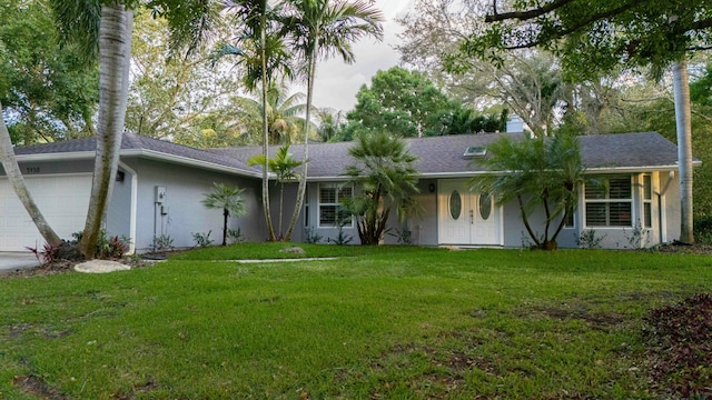 single story home featuring stucco siding, an attached garage, a front yard, and a shingled roof