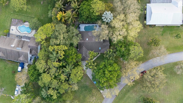 aerial view of property and surrounding area with a pool area