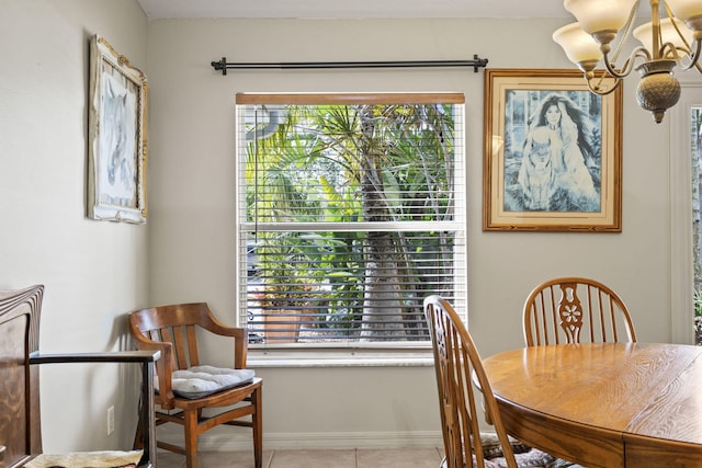 dining space featuring an inviting chandelier, light tile patterned floors, and baseboards