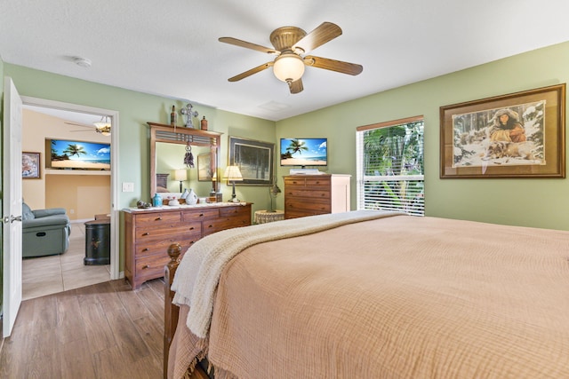 bedroom with ceiling fan and wood finished floors