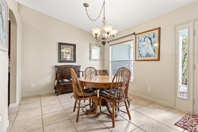 dining room featuring a wealth of natural light, light tile patterned flooring, and a notable chandelier