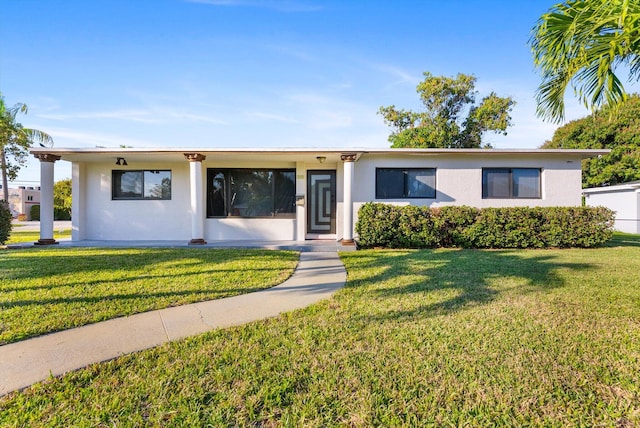 ranch-style home with a front lawn and stucco siding