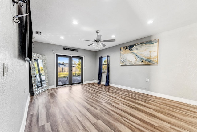 unfurnished room featuring recessed lighting, visible vents, ceiling fan, wood finished floors, and baseboards