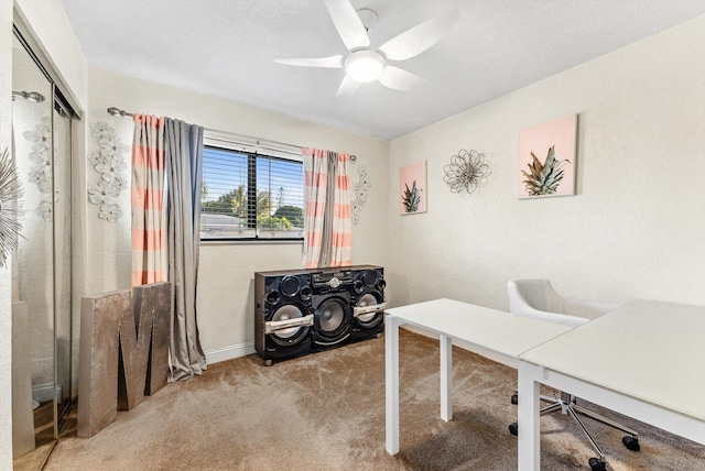 office with a ceiling fan and carpet