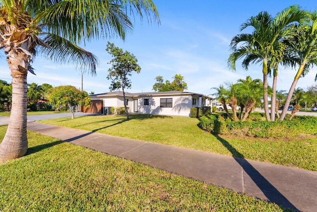 view of front of house with a garage, concrete driveway, and a front yard