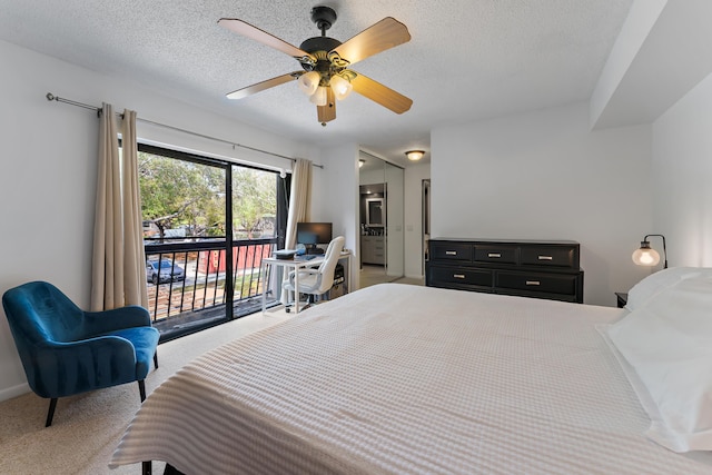 carpeted bedroom with a textured ceiling, ensuite bathroom, a ceiling fan, and access to exterior