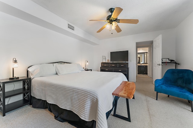 bedroom with a textured ceiling, visible vents, a ceiling fan, and light colored carpet