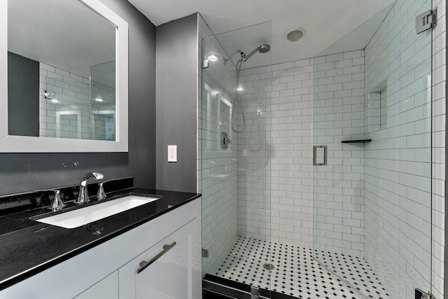 full bathroom with a stall shower and vanity