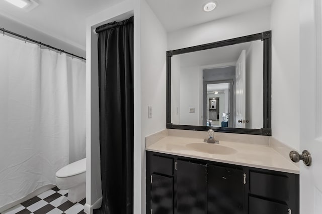 bathroom featuring toilet, tile patterned floors, and vanity