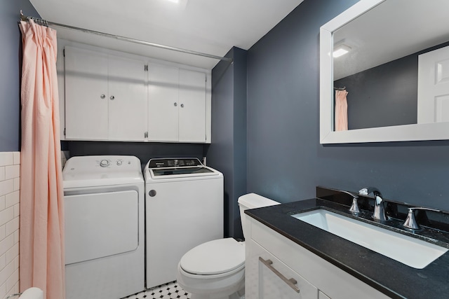 full bath featuring vanity, washing machine and clothes dryer, and toilet