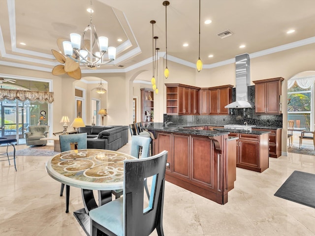 3934 Sherwood Blvd, Delray Beach, FL 33445 - kitchen featuring open shelves, a notable chandelier, arched walkways, wall chimney exhaust hood, and visible vents