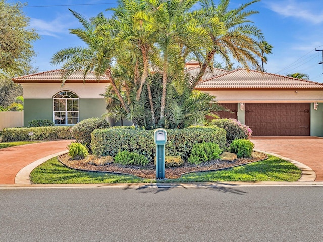 3934 Sherwood Blvd, Delray Beach, FL 33445 - mediterranean / spanish home with stucco siding, an attached garage, driveway, and a tile roof