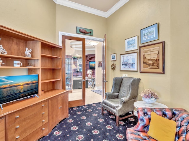 sitting room featuring carpet flooring and crown molding