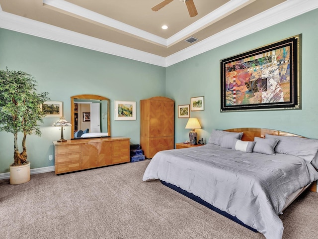 bedroom with visible vents, carpet flooring, crown molding, and a raised ceiling