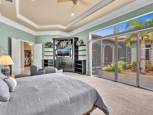 bedroom featuring ornamental molding, carpet, a tray ceiling, and access to outside