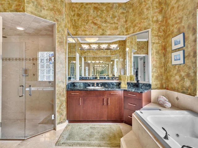 bathroom featuring a tub with jets, a stall shower, and vanity