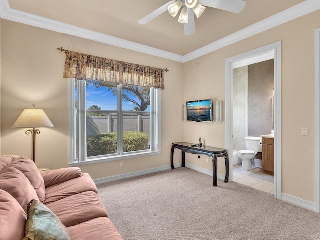 living room featuring light carpet, baseboards, a ceiling fan, and ornamental molding