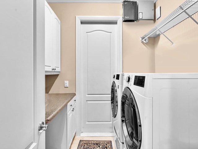 laundry room with cabinet space and washer and clothes dryer