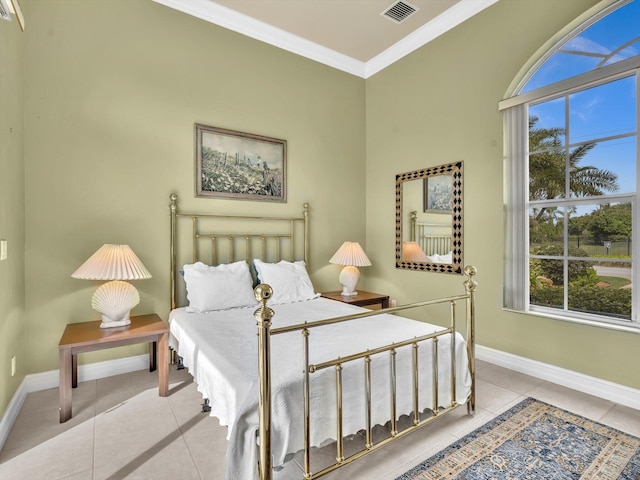 tiled bedroom with visible vents, baseboards, and crown molding