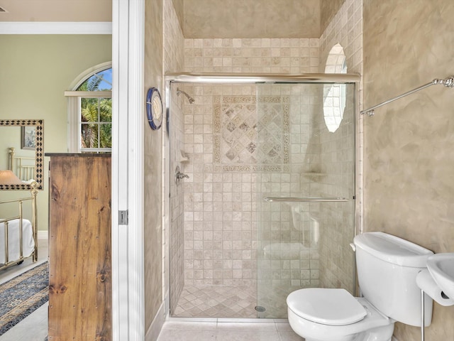 3934 Sherwood Blvd, Delray Beach, FL 33445 - bathroom with crown molding, tile patterned floors, a stall shower, and toilet