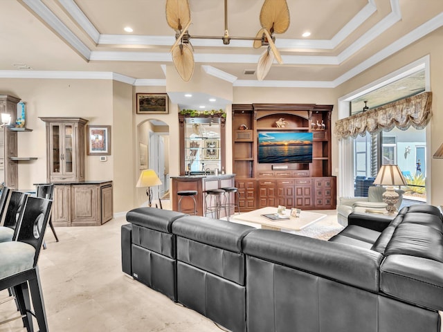 living area with visible vents, a tray ceiling, recessed lighting, arched walkways, and ornamental molding