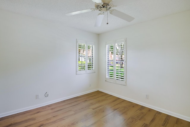 unfurnished room featuring a ceiling fan, a textured ceiling, baseboards, and wood finished floors