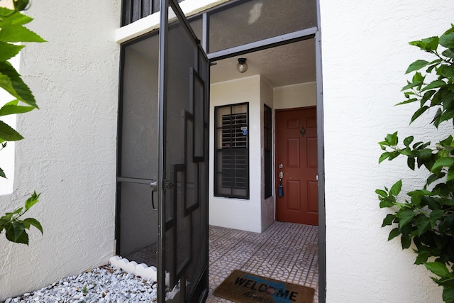 property entrance with stucco siding