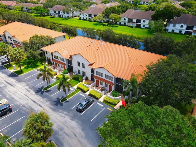 birds eye view of property featuring a water view and a residential view